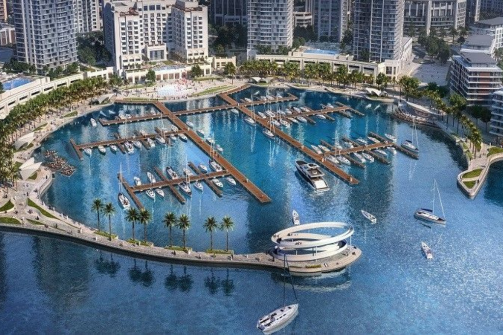 Luxury waterfront skyline of Dubai Creek Harbour at sunset with yachts and modern residential towers